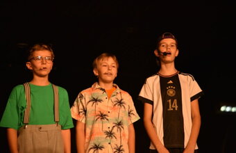 Das Bild zeigt die drei Solisten der 3?? nebeneinander stehend von links nach rechts Bob, Justus, Peter beim Singen eines Songs.